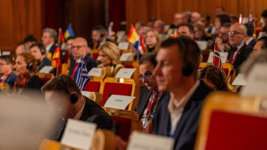 Many people sit and listen in the former Second Chamber.