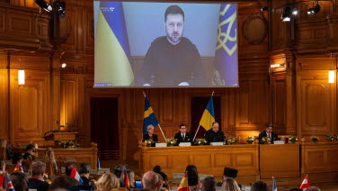 The President of Ukraine on the big screen in the former Second Chamber.