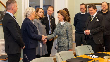 Queen Silvia greets people.