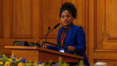 A woman delivers a speech in the former Second Chamber.
