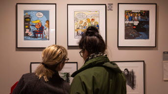 People in front of political drawings